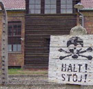 Danger sign in front of entrance to Auschwitz Concentration Camp