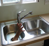 Garbage disposal with human hand reaching out of it