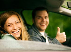 Happy couple driving in a car