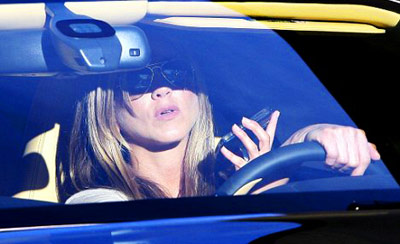 Jennifer Anniston texting while driving her car