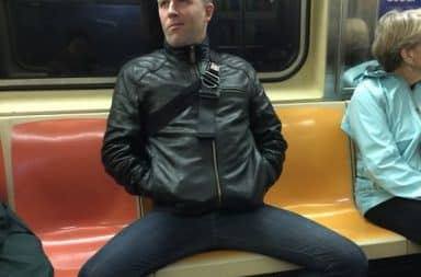Man is manspreading on the subway taking up three seats