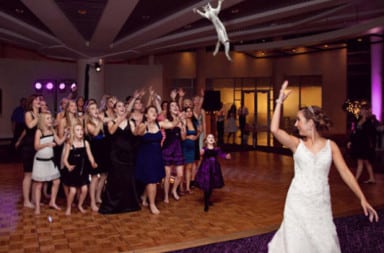 Bride tosses doll bouquet