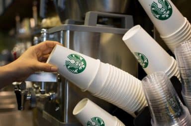 Starbucks employee grabbing cups