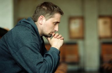 Man sitting silently in confused sadness over friend death grief