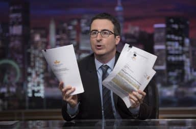 John Oliver on his show holding papers