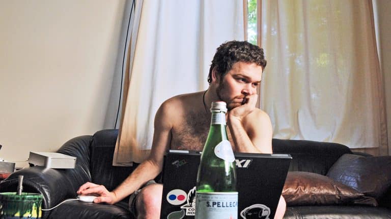 Man working from home naked on the couch