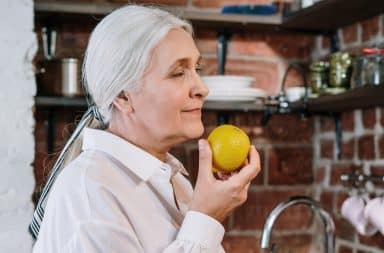 Sexy nymphomaniac grandmother smelling a lemon