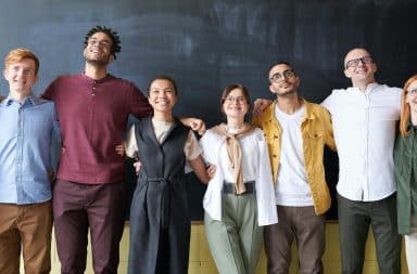 Employees posed by a chalkboard