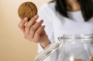 cookie jar holding cookie looking tasty mr cookie