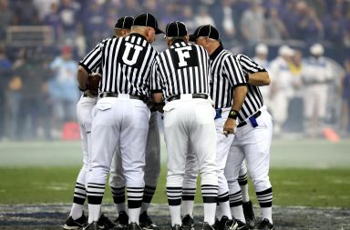 Football referees huddle