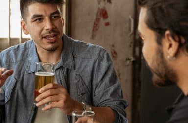 two guys talking to beers